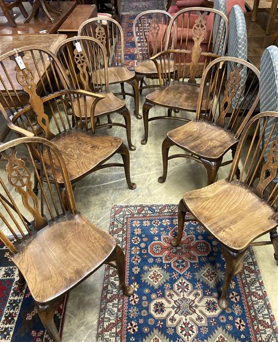 A set of eight early 20th century elm and beech Windsor wheelback dining chairs, with crinoline stretchers (two with arms)